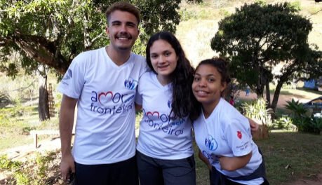 Um homem de duas mulheres, do Grupo Amor sem Fronteira, abraçados.